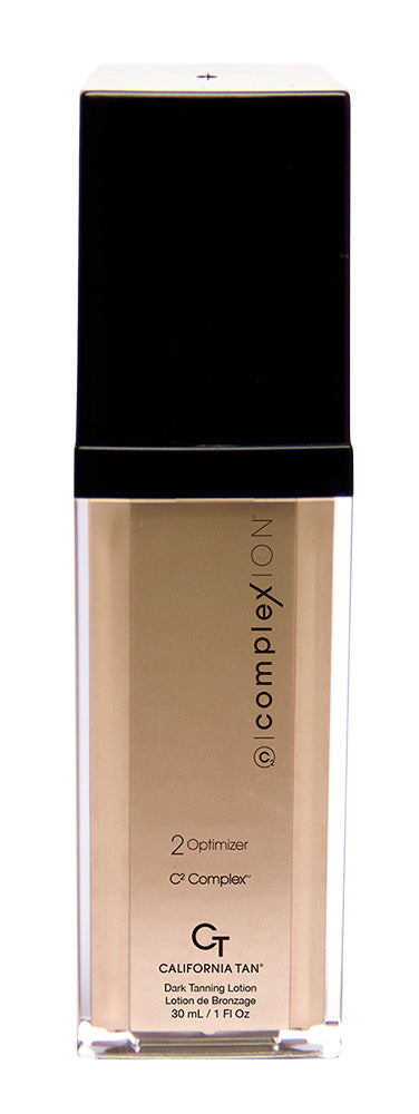 Complexion California Tan Quick Tanning Lotion in a clear rectangular bottle with a black cap, showing the beige-tan liquid inside.
