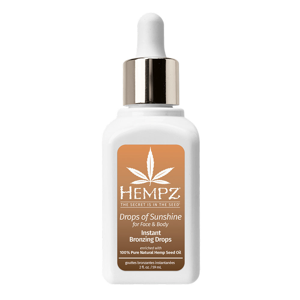 A white bottle of Hempz Drops of Sunshine Instant Bronzing Drops with a gold and white dropper cap, set against a plain white background.