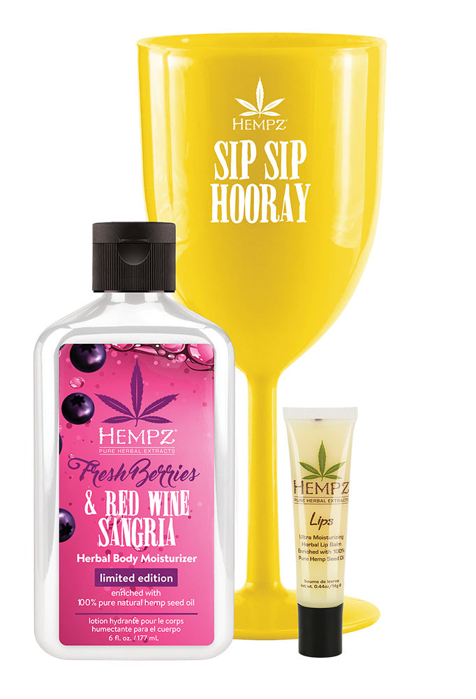 Hempz product set including a bottle, a yellow glass, and a tube on a white background