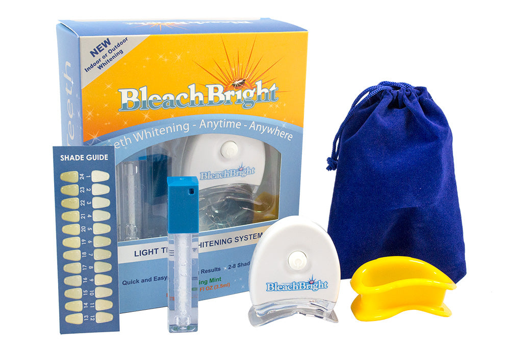 Bleach Bright teeth whitening system with packaging, light, shades guide, and blue pouch on a white background.