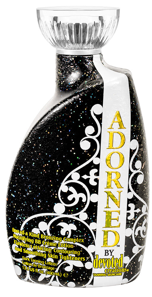 Decorative bottle labeled 'Adorned by Devoted' with intricate designs and gold text.