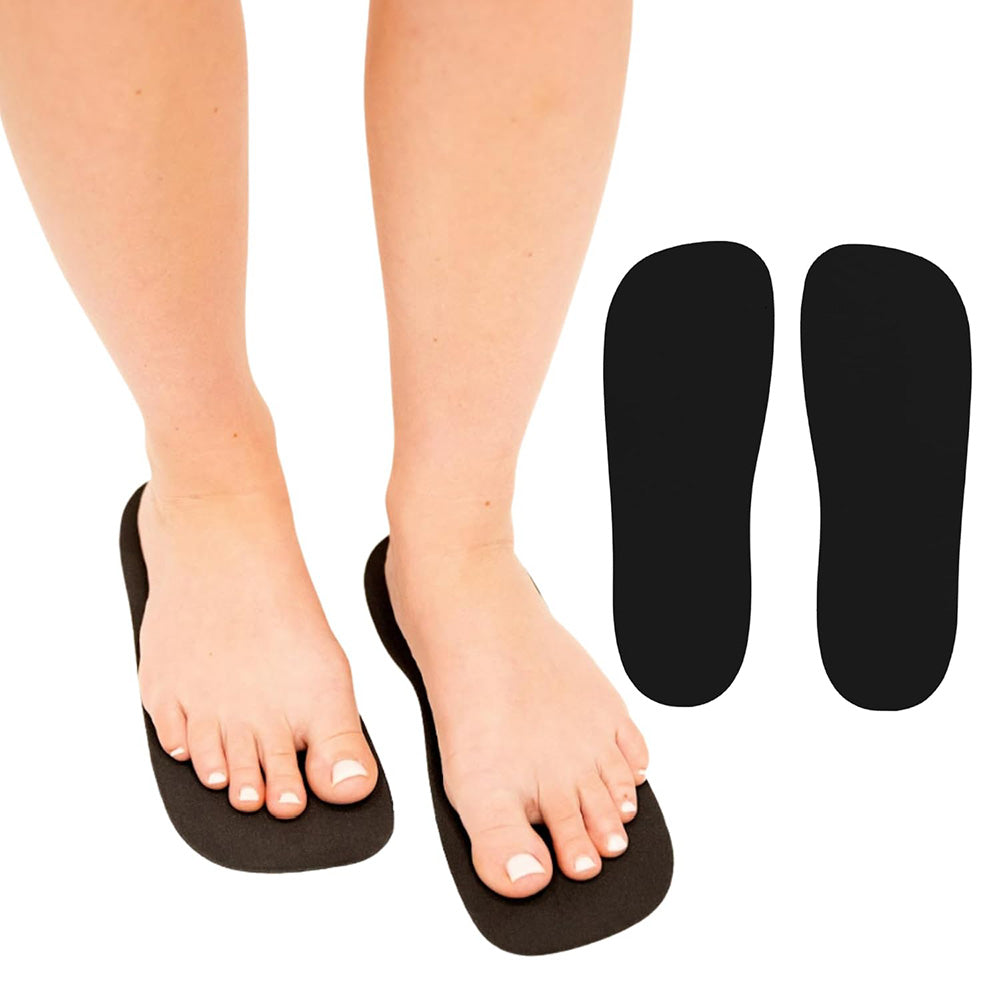 Black foot orthotics with a person wearing black sandals on a white background