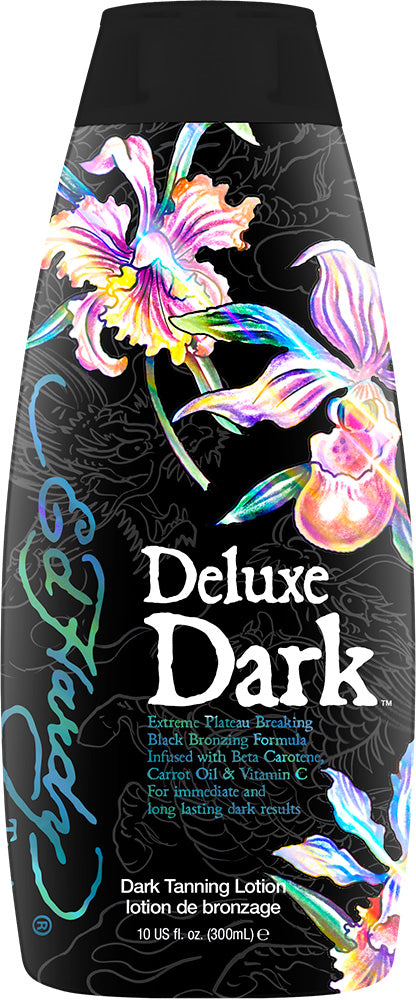 A bottle of Ed Hardy Deluxe Dark tanning lotion with a colorful floral design on the label.
