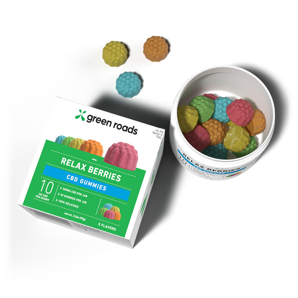 Green Roads CBD gummies packaging with colorful gummies and a container on a white background