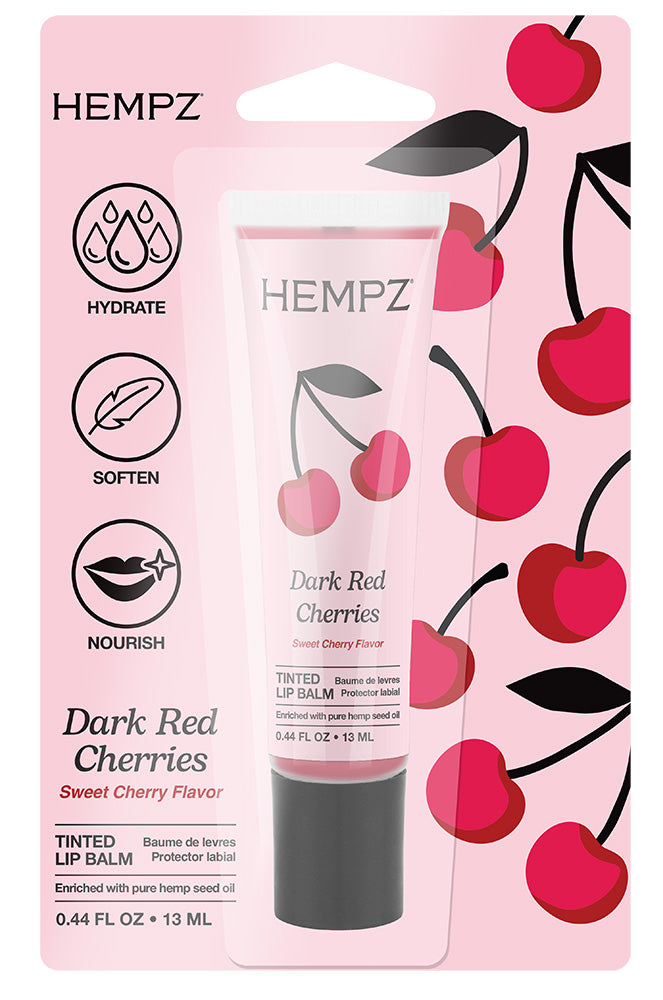 Hempz Dark Red Cherries tinted lip balm packaging on a pink background with cherry illustrations.