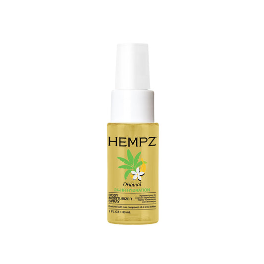 A bottle of HEMPZ 24-Hour body spray on a plain white background. The product features a clear bottle showing a golden-yellow liquid inside, a white spray nozzle cap, and a label with black text, a green cannabis leaf, and a small white flower.