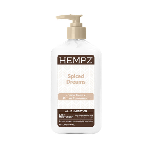 A bottle of HEMPZ Spiced Dreams Tonka Bean and Warm Cardamom body moisturizer, featuring a white bottle with a beige pump and a brown and white label.
