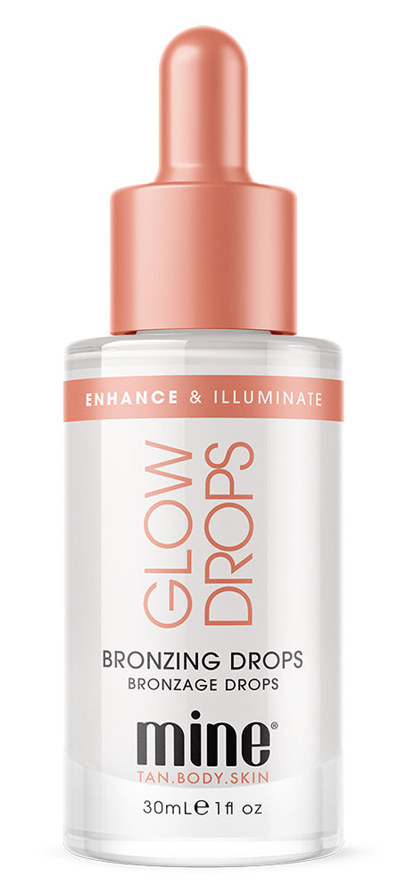 A bottle of mine brand Glow Drops Bronzing Drops, featuring a clear glass bottle with a metallic rose gold dropper cap and a white label with rose gold and black text.