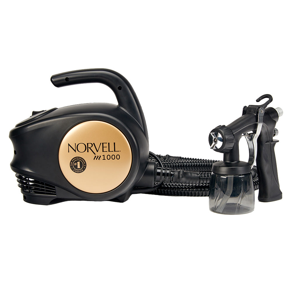 Black and gold Norvell M1000 tanning machine on a white background