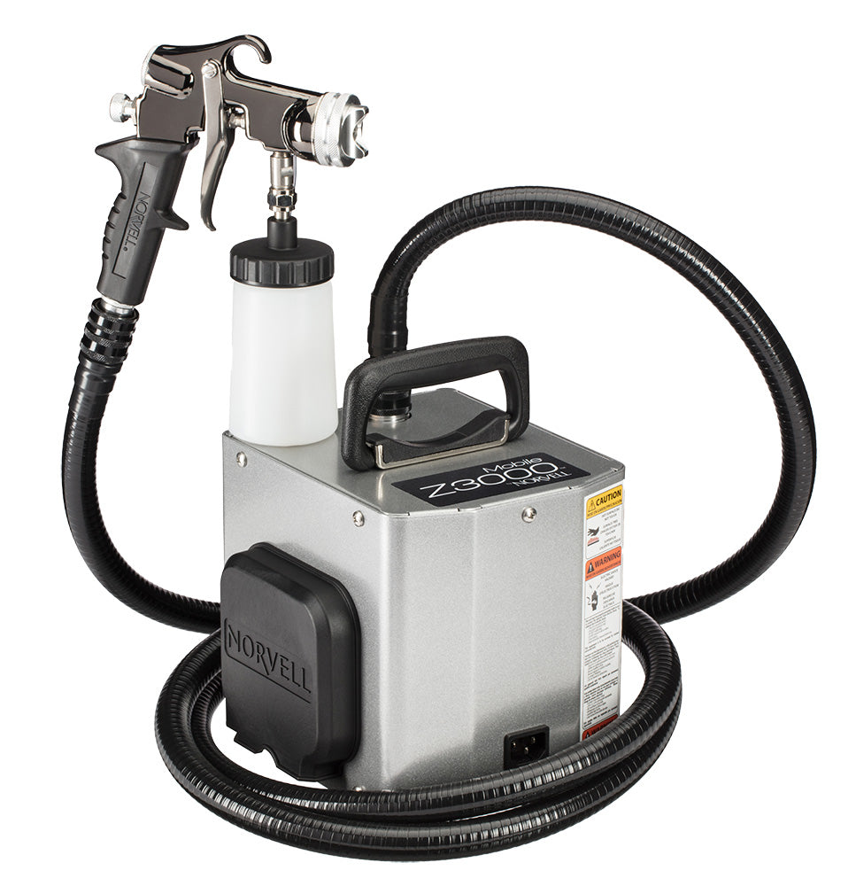 Spray gun with hose and nozzle on a white background