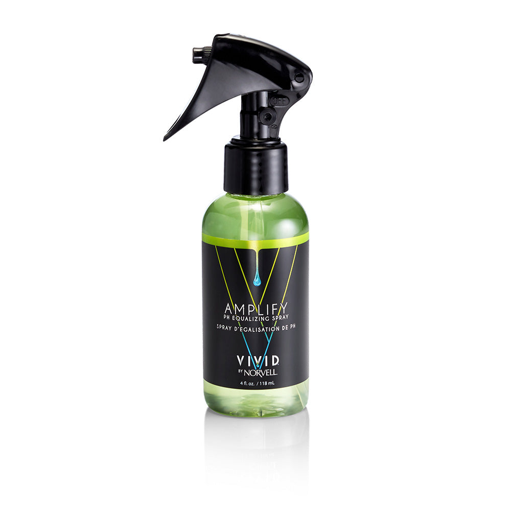 Green spray bottle with black nozzle on a white background