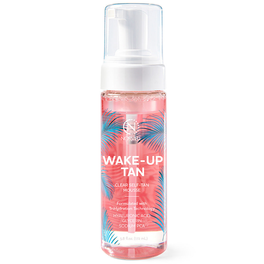 Bottle of 'Wake-Up Tan' mousse with palm leaf design on a white background