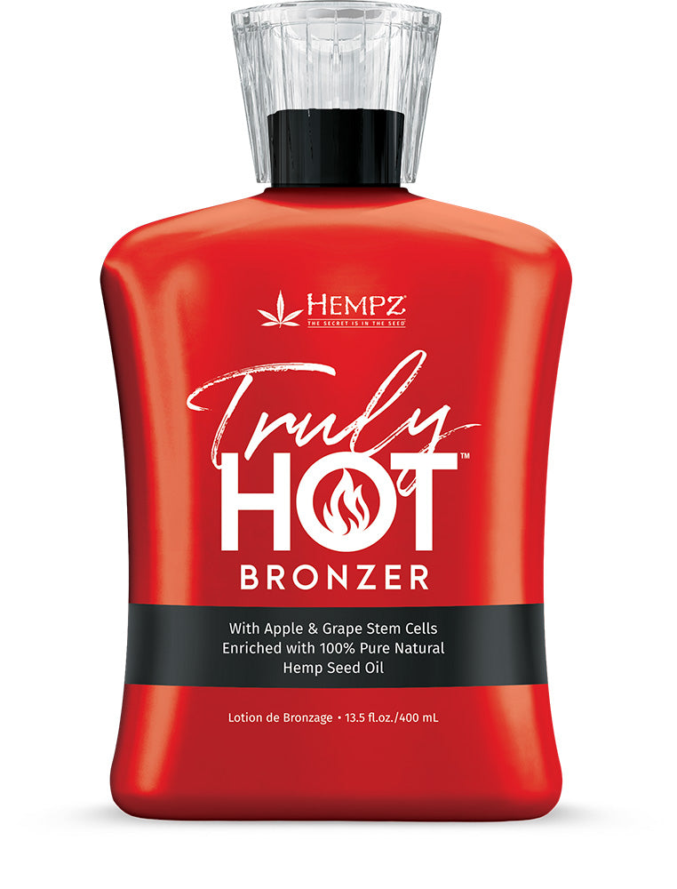 Red bottle of Hempz Truly Hot Bronzer on a white background