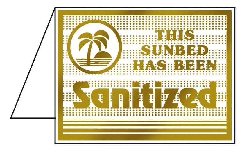 Gold sign with palm tree design and text 'This sunbed has been sanitized' on a white background