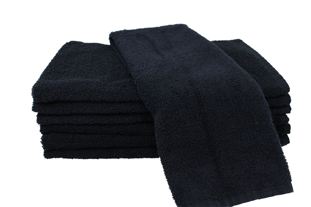 Stack of black folded towels on a white background