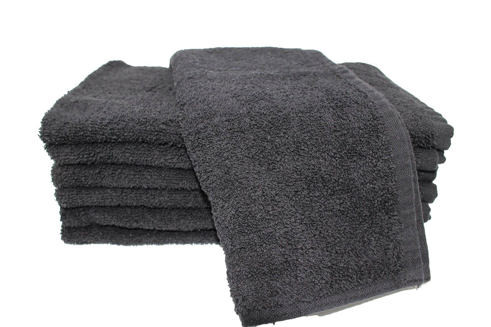 Stack of dark gray towels on a white background